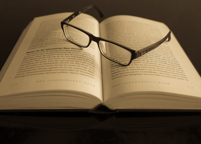 reading glasses sitting on open book